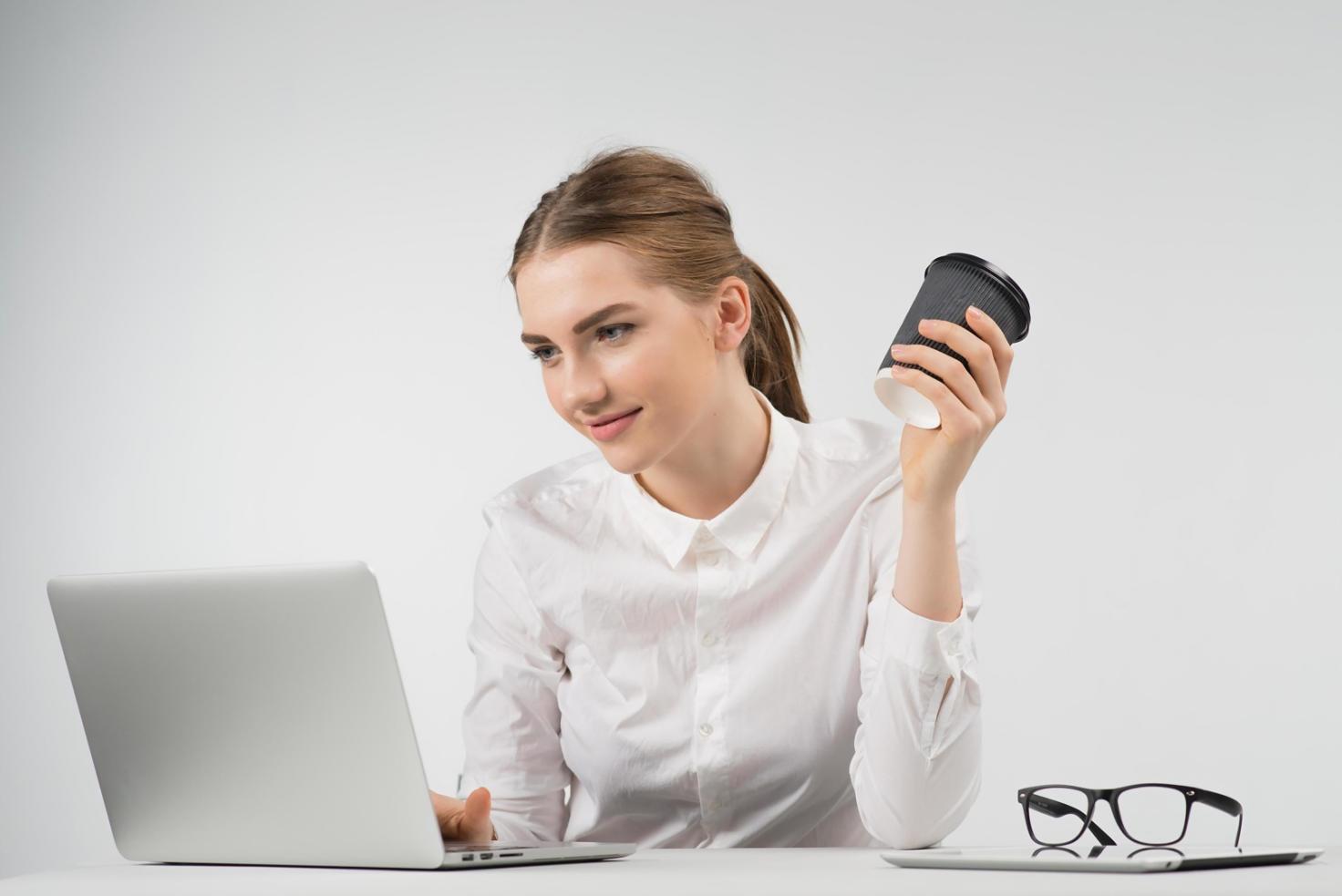 Student working through budget planning materials at their own pace with laptop and planning notebooks